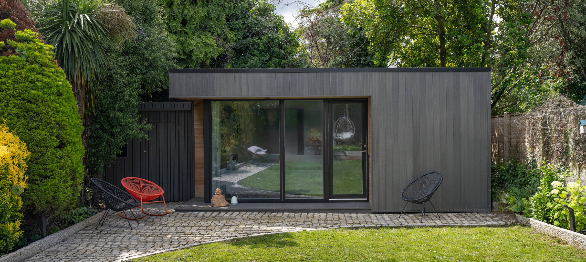 A slate-grey Shomera garden studio showing the cladding and glazing detail