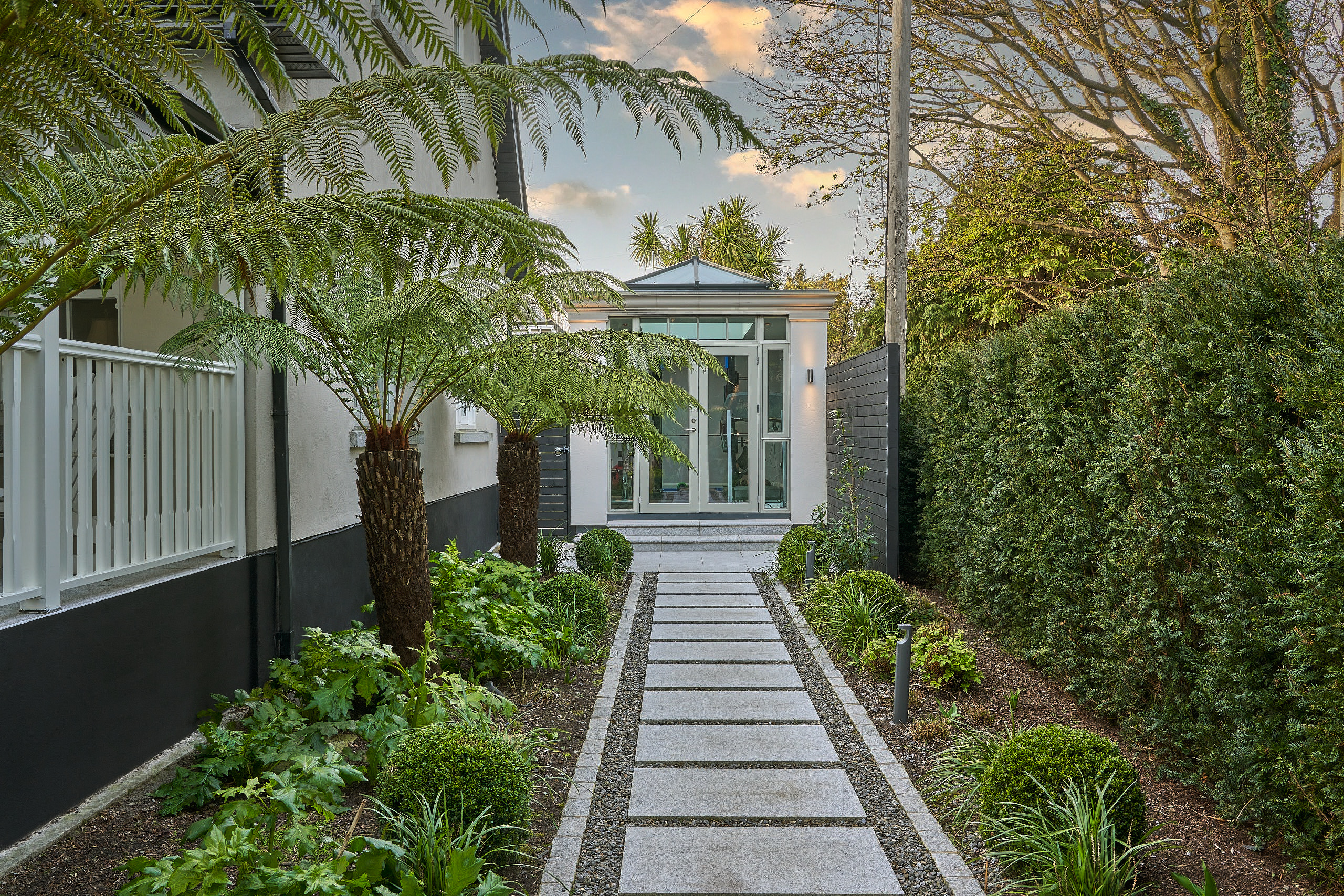 The orangery-style Oolart studio in its garden setting