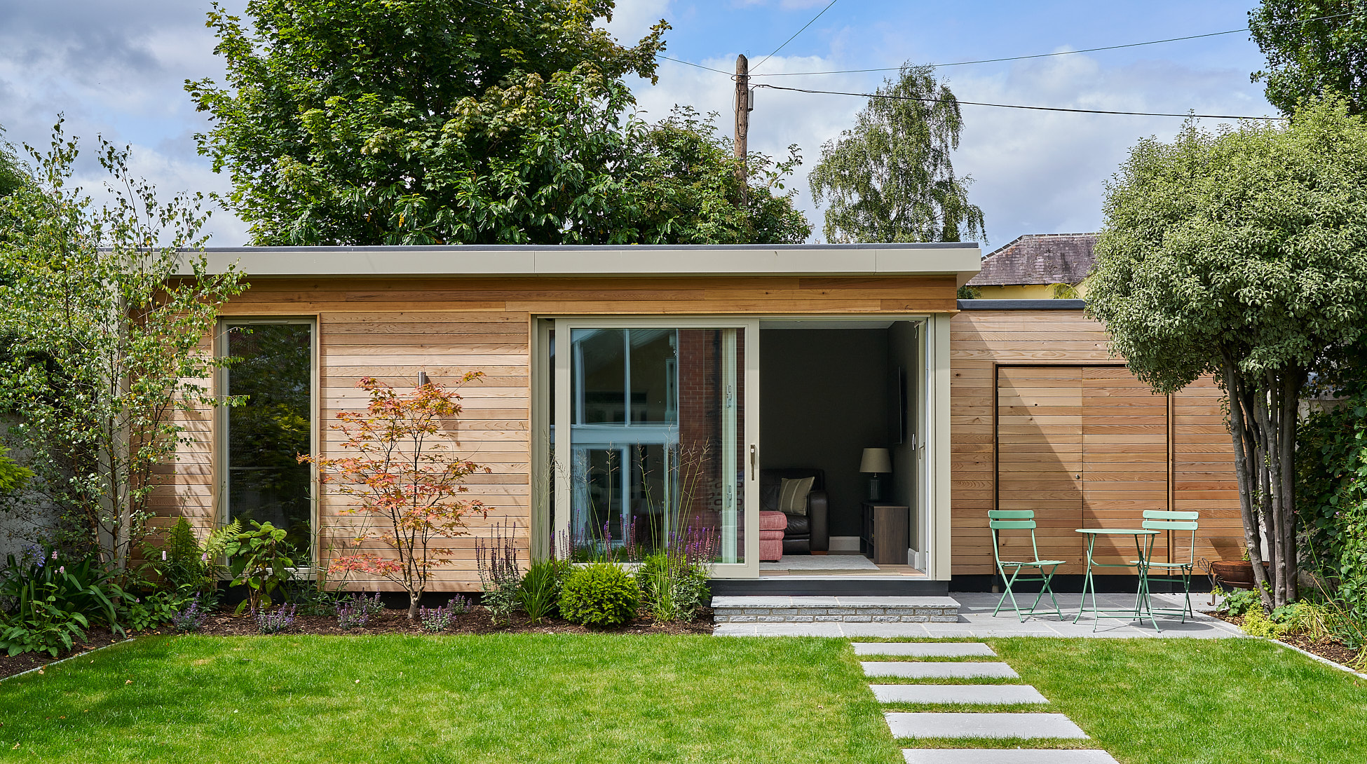 The Templemore Avenue studio's cedar cladding and glazing at dusk