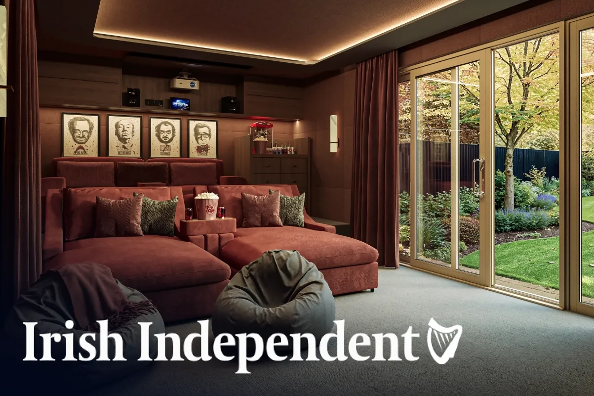 A home cinema garden studio with red sofas and a projector, with the Irish Independent logo