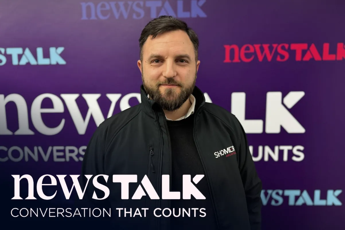 A man in a Shomera jacket standing in front of a Newstalk backdrop